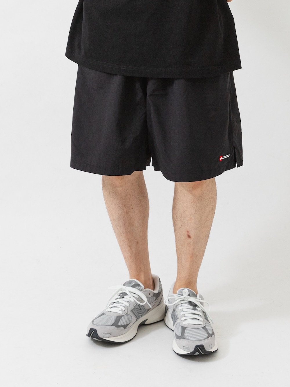 ブラック系のTシャツ/カットソー、ブラック系のその他パンツ、グレー系のスニーカーを着用したメンズの夏コーディネートの3枚目の写真