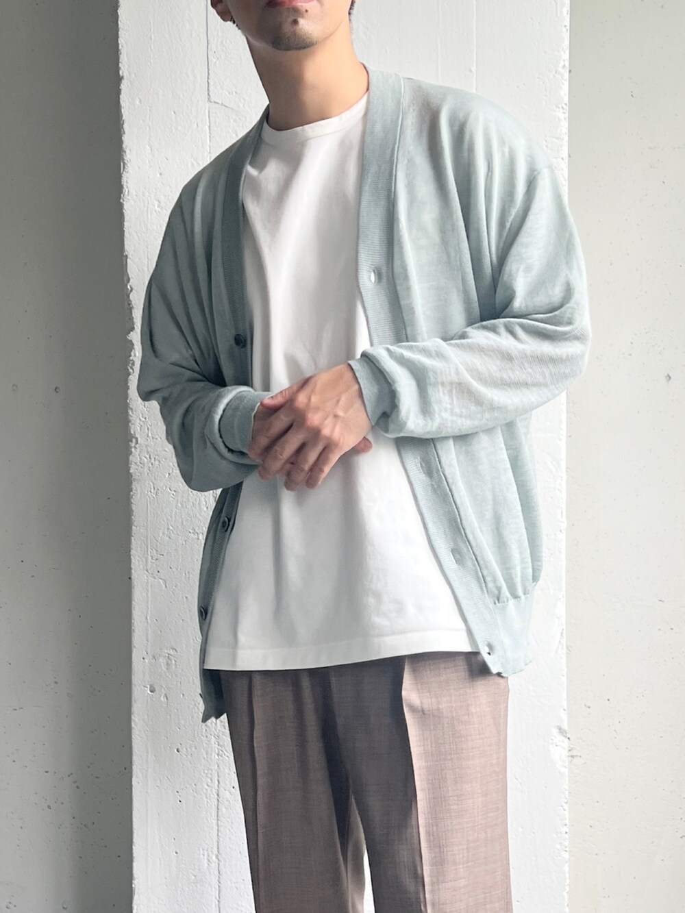 ブルー系のニット/セーター、ベージュ系のその他パンツ、ホワイト系のTシャツ/カットソーを着用したメンズの夏コーディネートの5枚目の写真