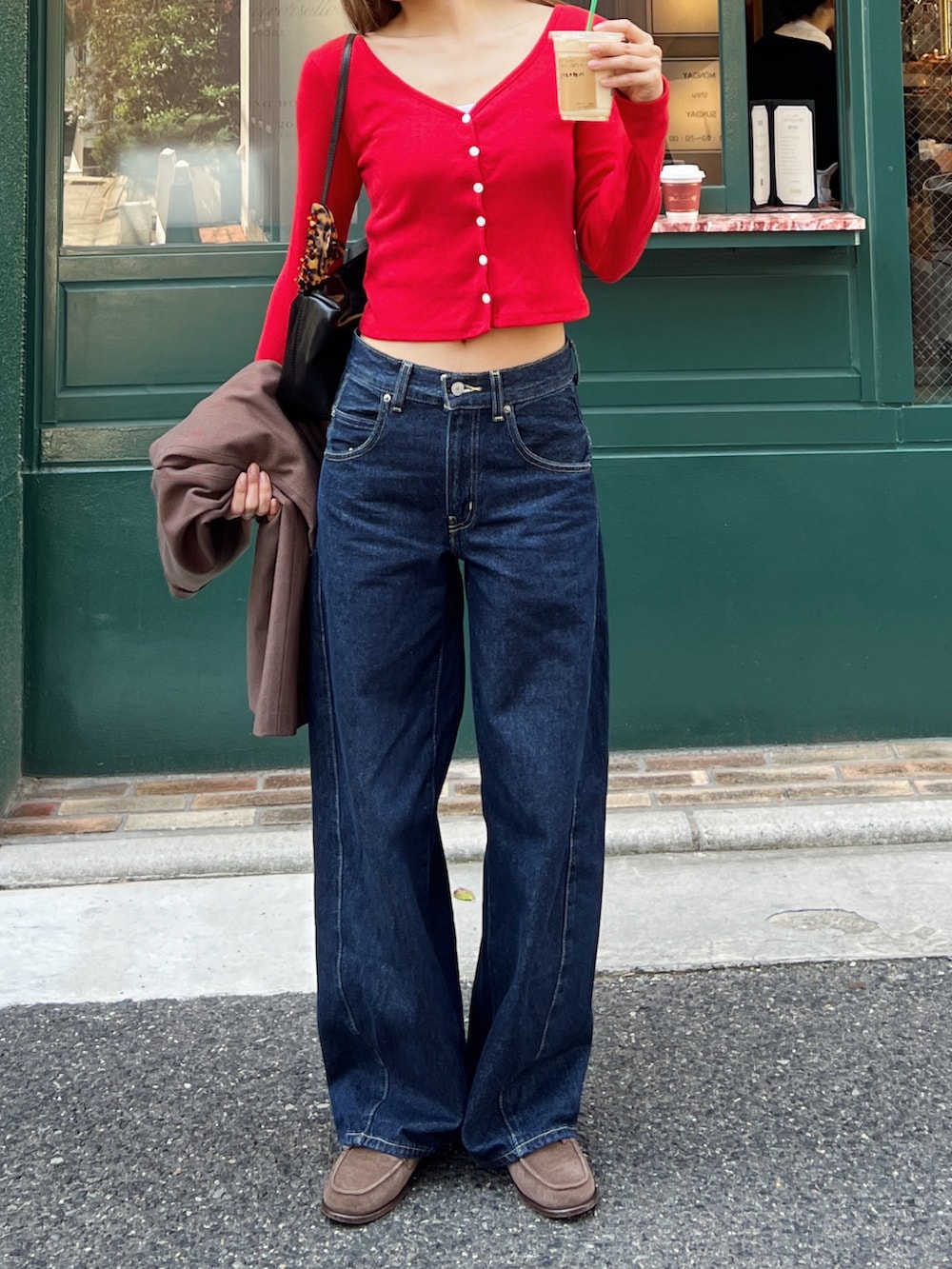 レッド系のカーディガン/ボレロ、ブルー系のデニムパンツ、ブラウン系のモカシン/デッキシューズを着用したレディースの春コーディネートの2枚目の写真