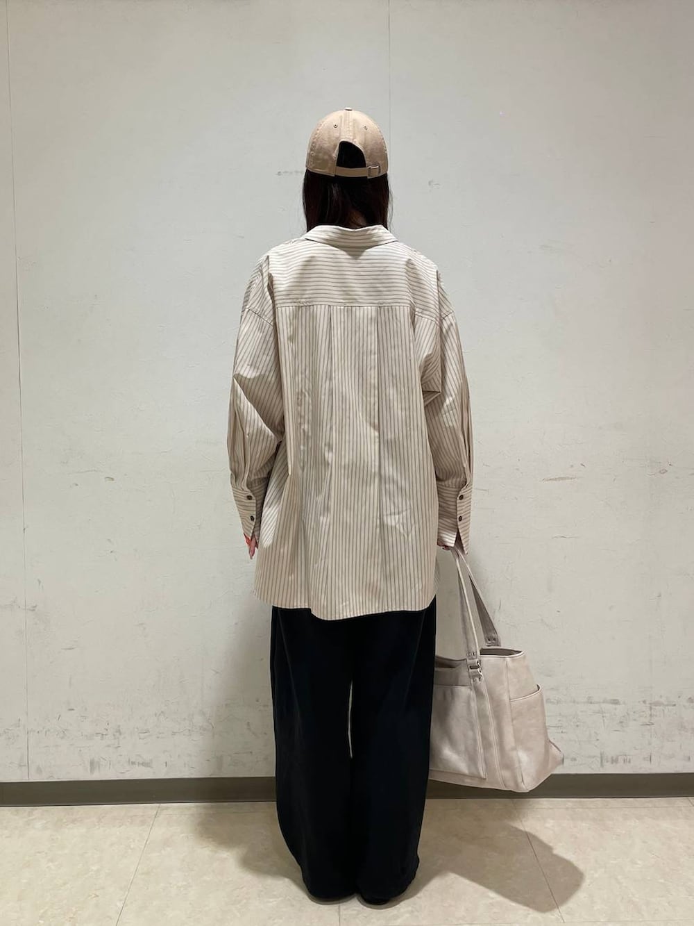 イエロー系のタンクトップ、ホワイト系のTシャツ/カットソー、ホワイト系のトートバッグを着用したレディースの春コーディネートの3枚目の写真