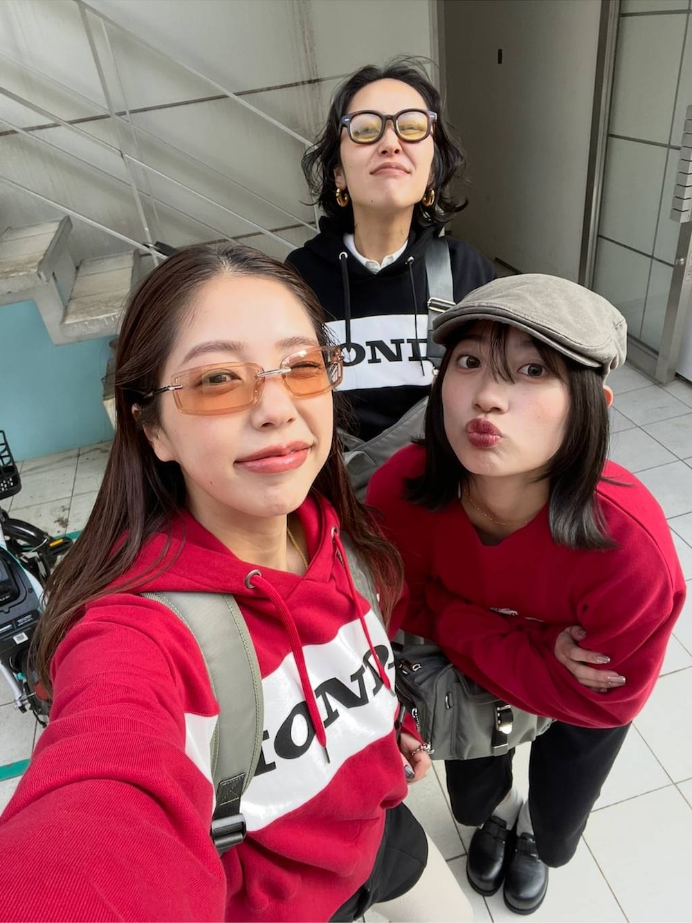 グレー系のスラックス、ホワイト系のシャツ/ブラウス、グリーン系のトートバッグを着用したレディースの冬コーディネートの2枚目の写真