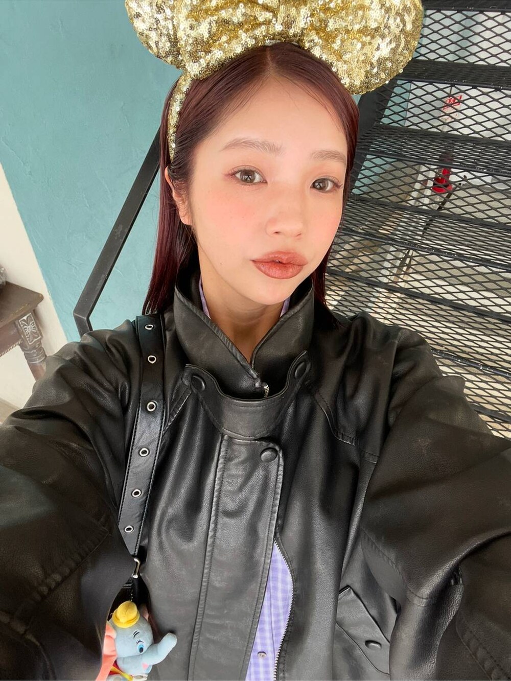 ブラック系のローファー、ブラック系のショルダーバッグ、ブラック系のライダースジャケットを着用したレディースの冬コーディネートの6枚目の写真