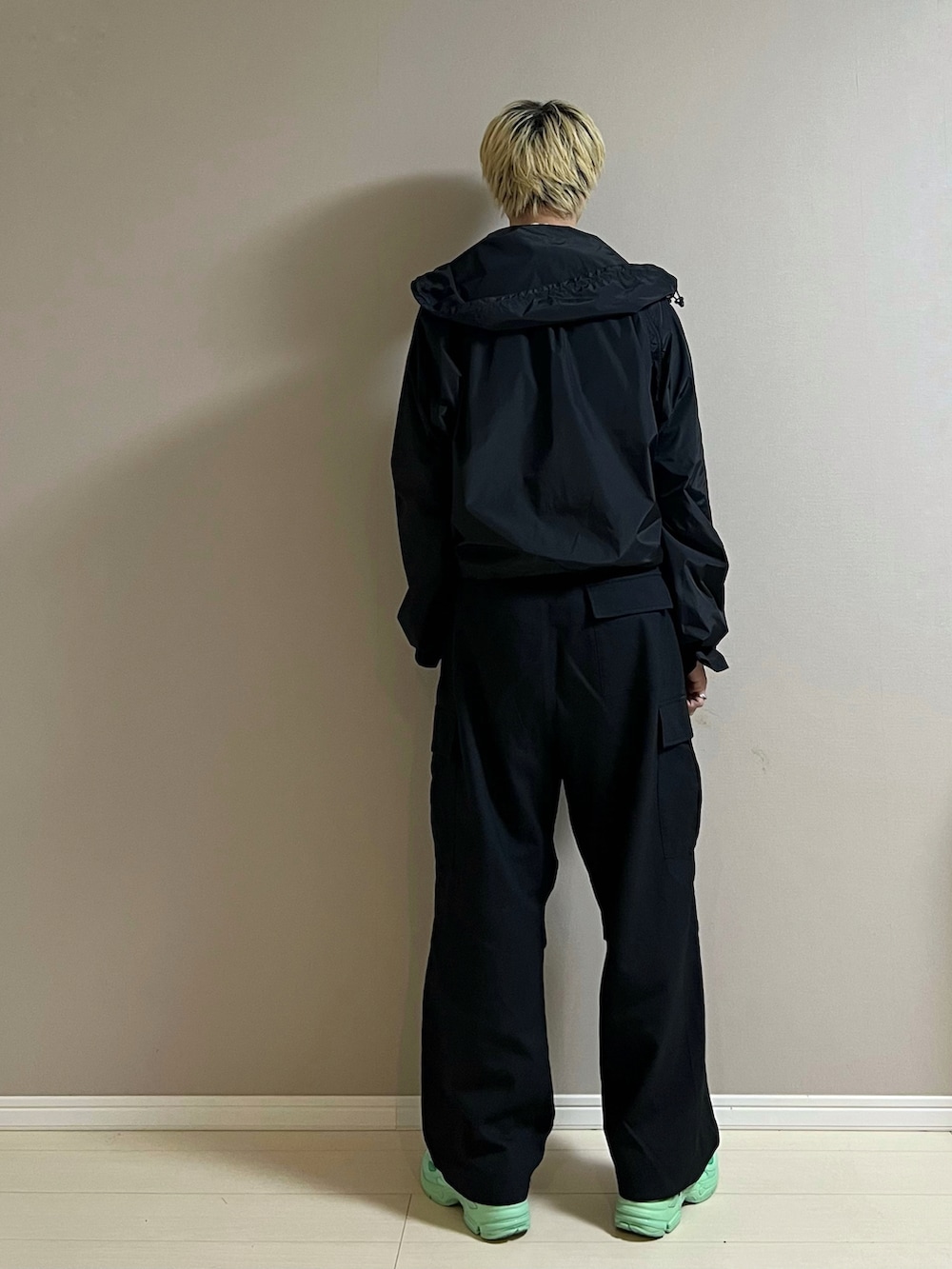 ブルー系のスニーカー、ブラック系のカーゴパンツ、ブラック系のナイロンジャケットを着用したメンズの秋コーディネートの3枚目の写真