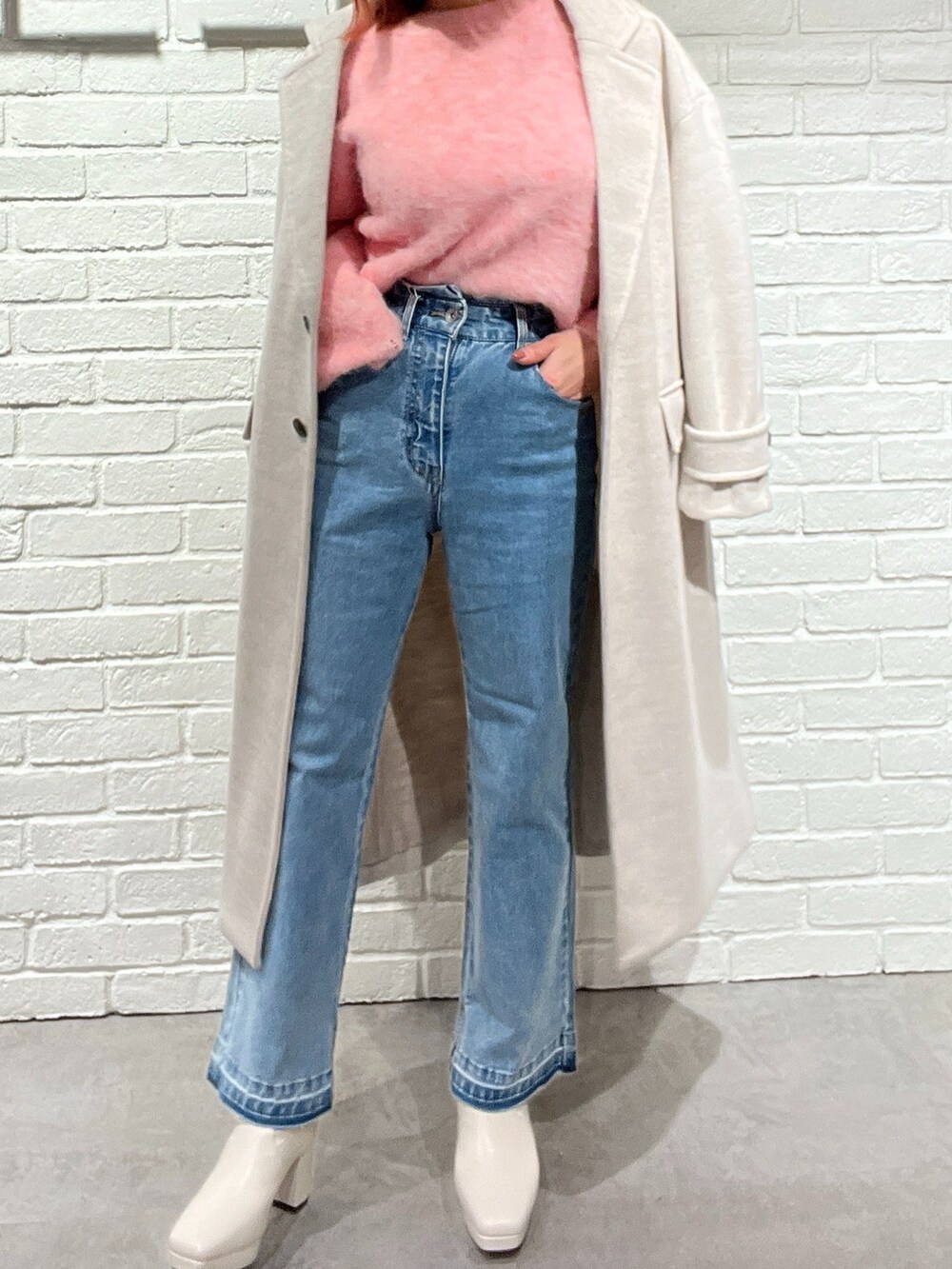 ピンク系のニット/セーター、ホワイト系のブーツ、ベージュ系のチェスターコートを着用したレディースの冬コーディネートの5枚目の写真