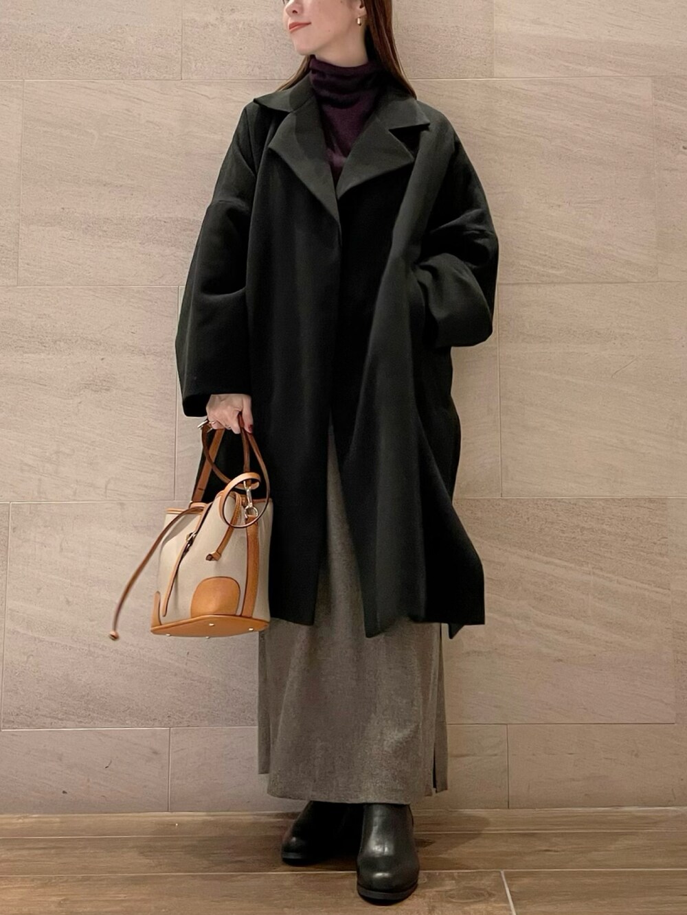 ブラウン系のワンピース、パープル系のニット/セーター、ブラック系のその他アウターを着用したレディースの冬コーディネートの2枚目の写真