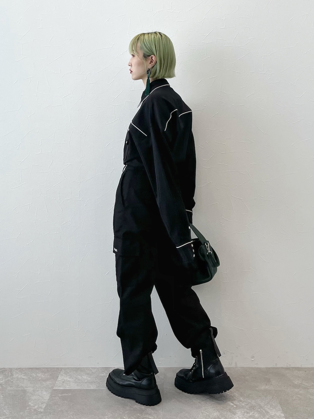 ブラック系のシャツ/ブラウス、グリーン系のショルダーバッグ、ブラック系のカーゴパンツを着用したレディースの秋コーディネートの2枚目の写真