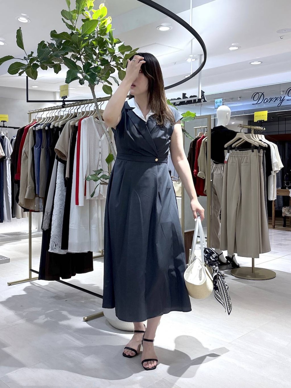 グレー系のワンピース、ブラック系のサンダル、ブルー系のストール/ショールを着用したレディースの夏コーディネートの2枚目の写真