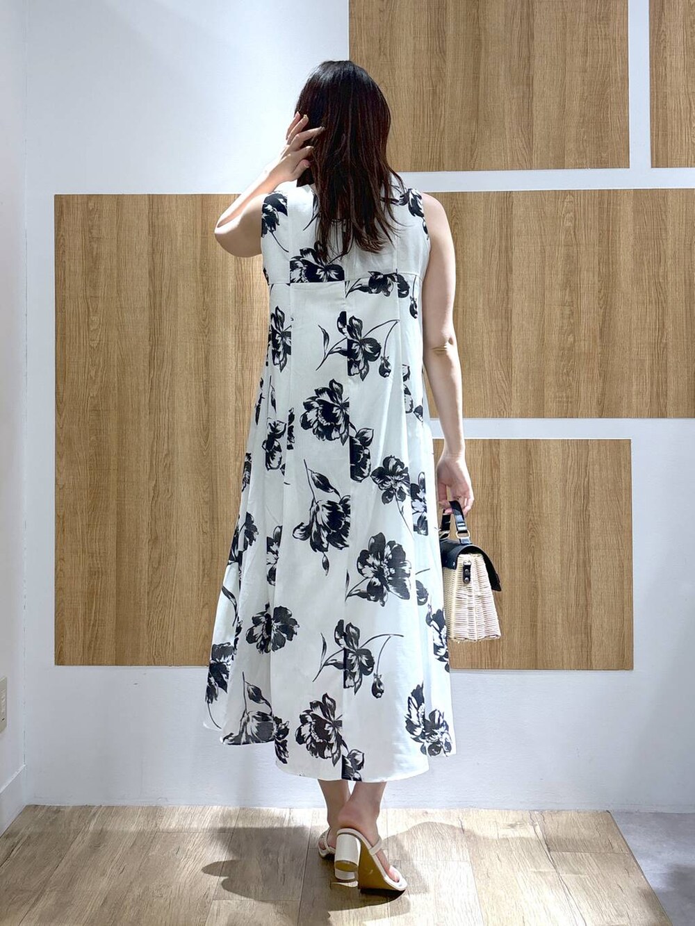 ブラック系のかごバッグ、ホワイト系のサンダル、ホワイト系のカーディガン/ボレロを着用したレディースの春コーディネートの5枚目の写真