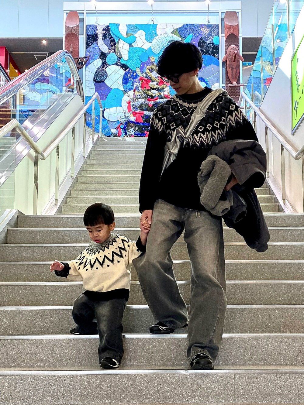 ブラック系のニット/セーター、グレー系のデニムパンツ、ブラック系のニット/セーターを着用したメンズの冬コーディネートの3枚目の写真