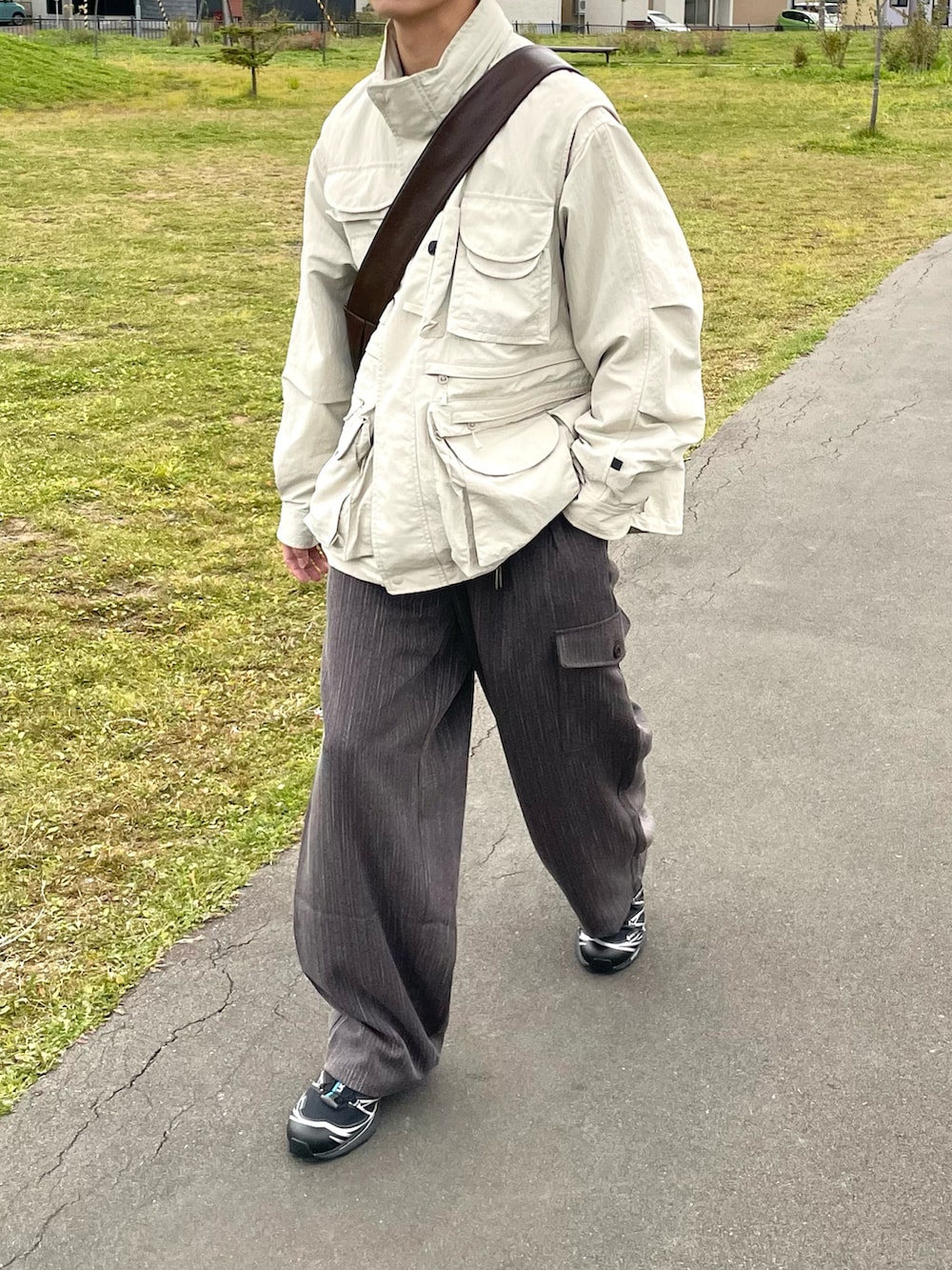 ブラウン系のその他パンツ、ベージュ系のブルゾン、ブラック系のスニーカーを着用したメンズの秋コーディネートの5枚目の写真