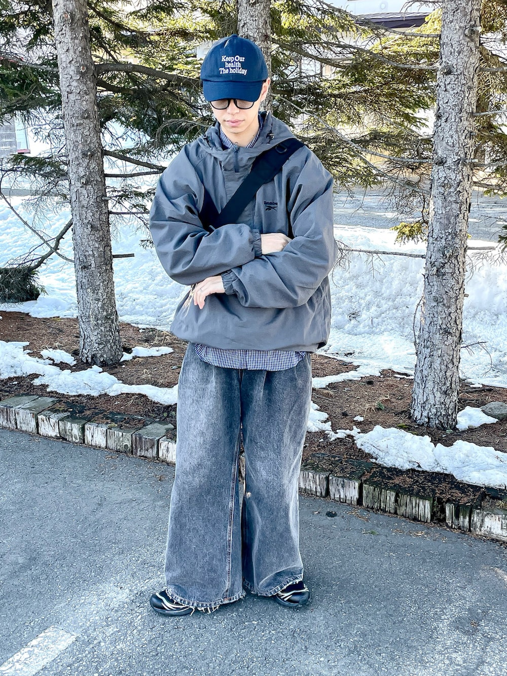 グレー系のナイロンジャケット、ブルー系のシャツ/ブラウス、ブラック系のデニムパンツを着用したメンズの春コーディネートの2枚目の写真