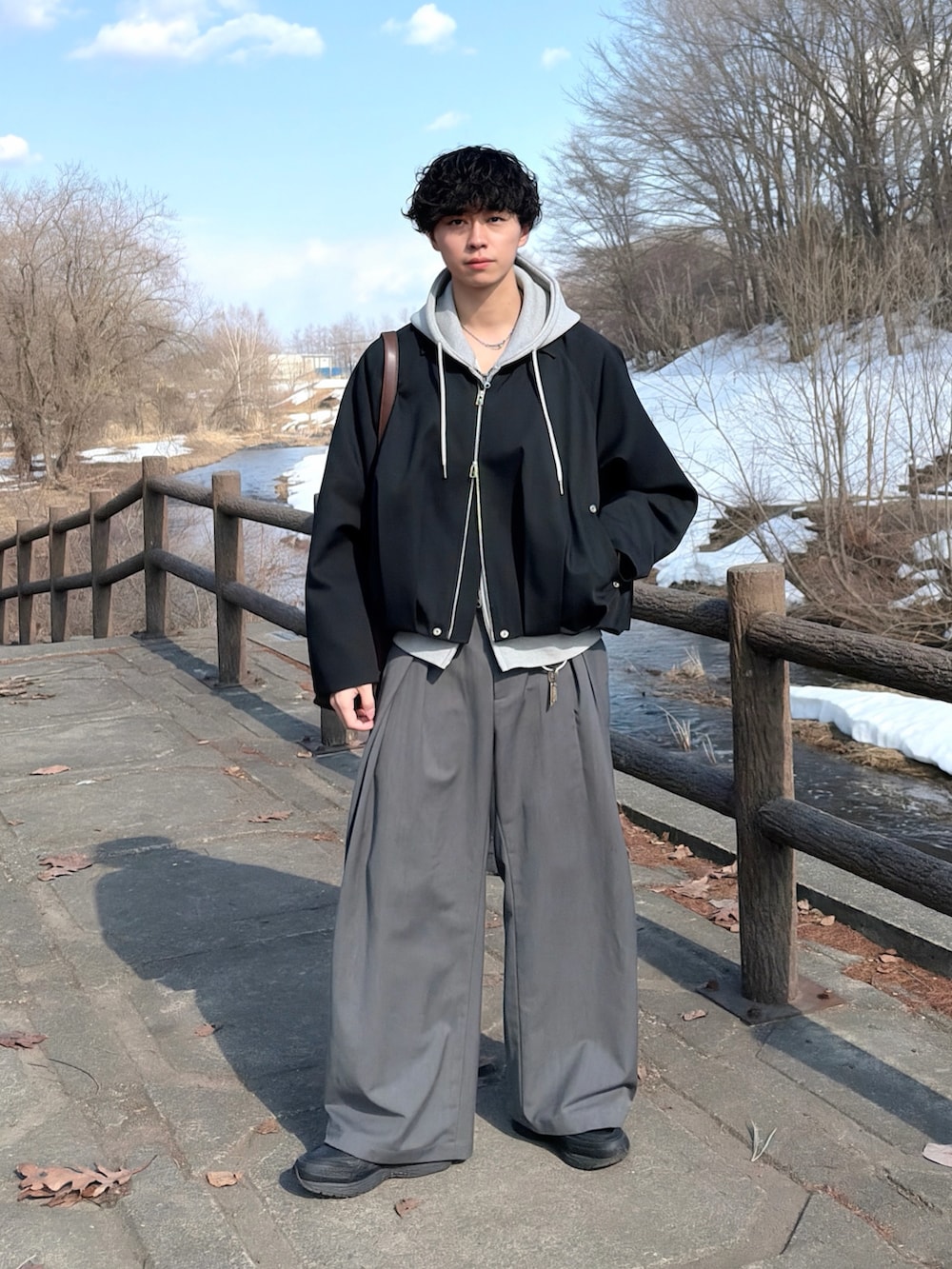 その他のブルゾン、ブラウン系のショルダーバッグ、グレー系のスラックスを着用したメンズの春コーディネートの4枚目の写真