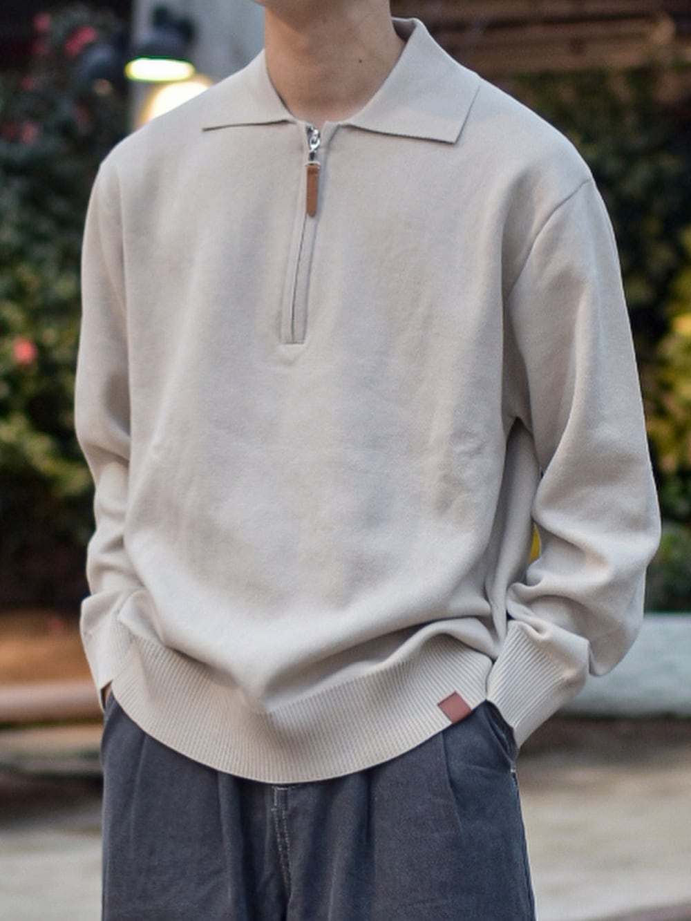 ベージュ系のニット/セーター、グレー系のステンカラーコート、グレー系のデニムパンツを着用したメンズの冬コーディネートの5枚目の写真