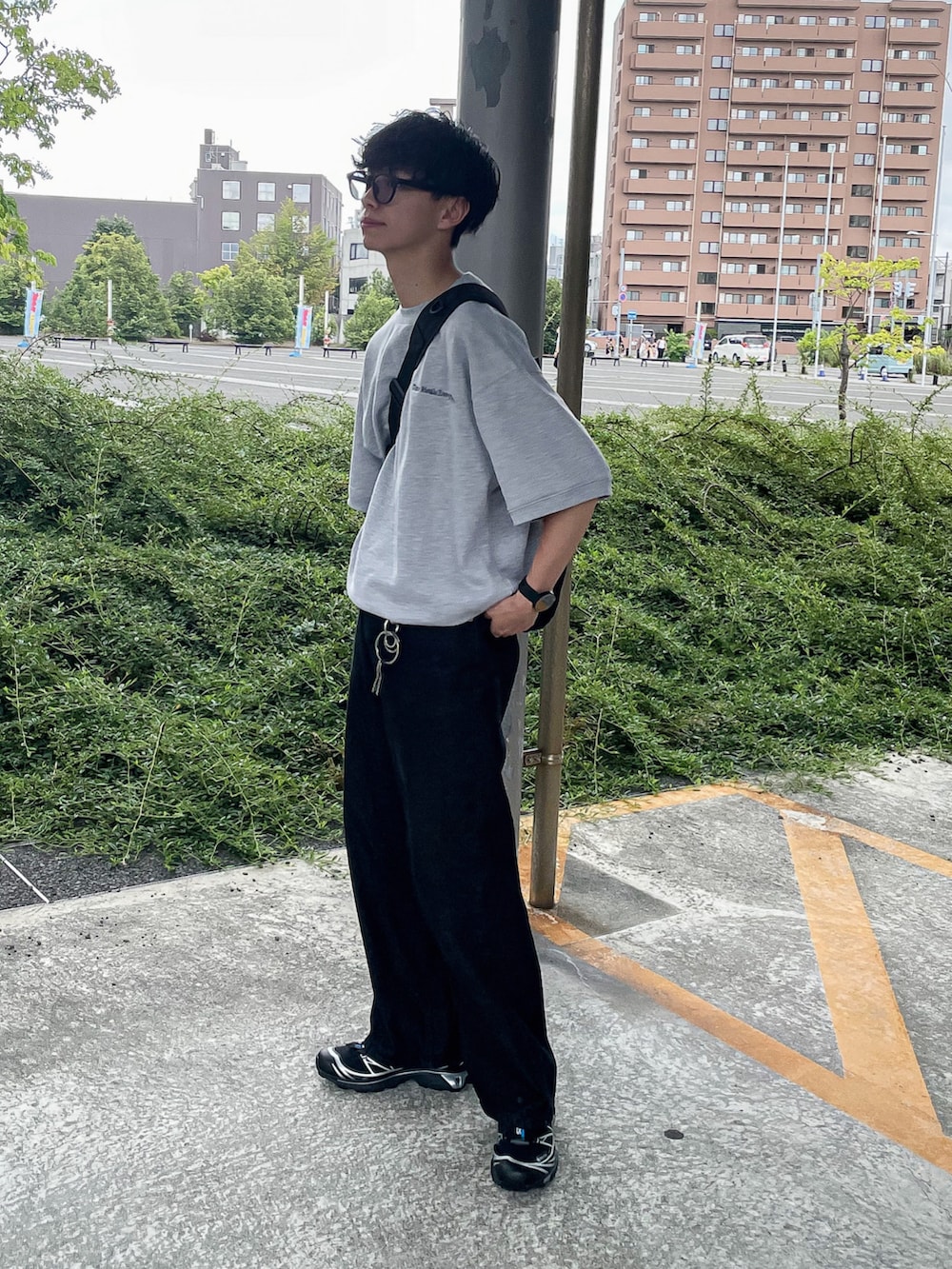 グレー系のTシャツ/カットソー、ブラック系のスニーカー、ブラック系のショルダーバッグを着用したメンズの夏コーディネートの2枚目の写真