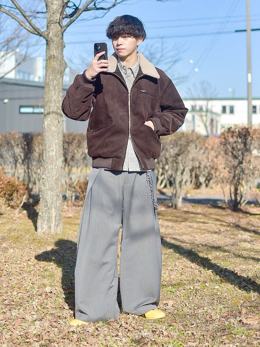 ブラウン系のブルゾン、ホワイト系のシャツ/ブラウス、グレー系のスラックスを着用したメンズの秋コーディネートの3枚目の写真