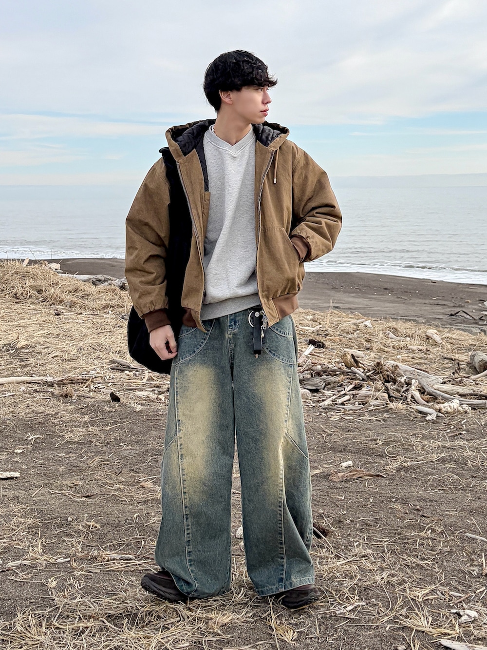 ブラウン系のその他アウター、ブルー系のデニムパンツ、グレー系のスウェットを着用したメンズの冬コーディネートの4枚目の写真