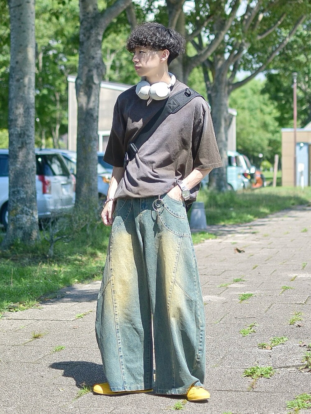 ブラウン系のTシャツ/カットソー、ブルー系のデニムパンツ、イエロー系のスニーカーを着用したメンズの夏コーディネートの2枚目の写真