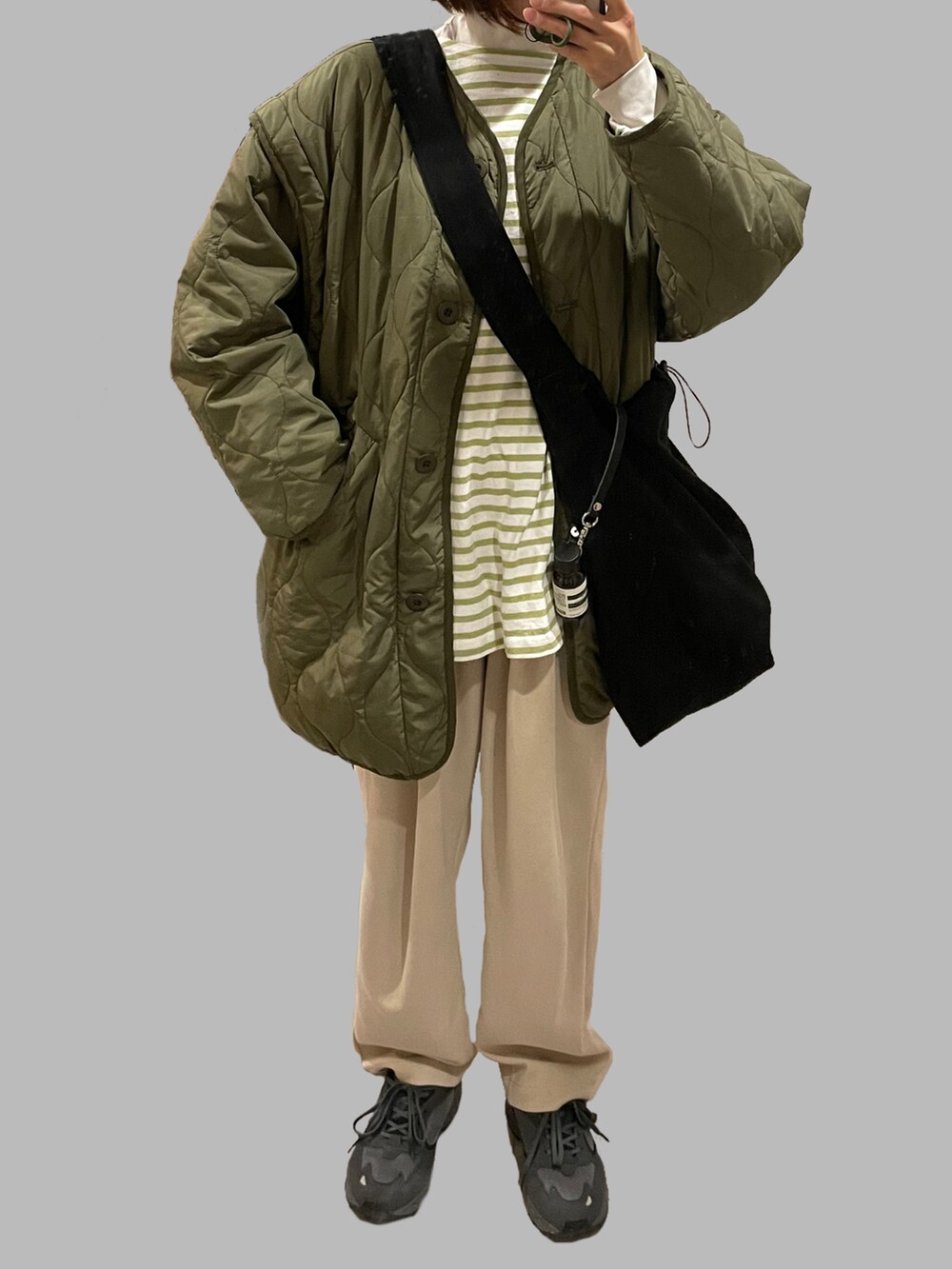 グリーン系のノーカラージャケット、グリーン系のTシャツ/カットソー、ブラック系のショルダーバッグを着用したレディースの冬コーディネートの2枚目の写真