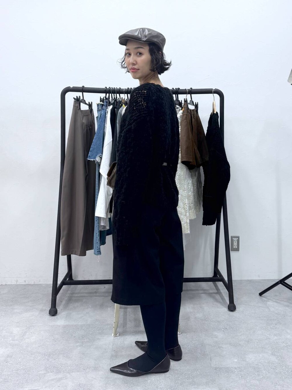 ブラック系のその他パンツ、ブラック系のニット/セーター、ブラウン系のハンチング/ベレー帽を着用したレディースの秋コーディネートの2枚目の写真