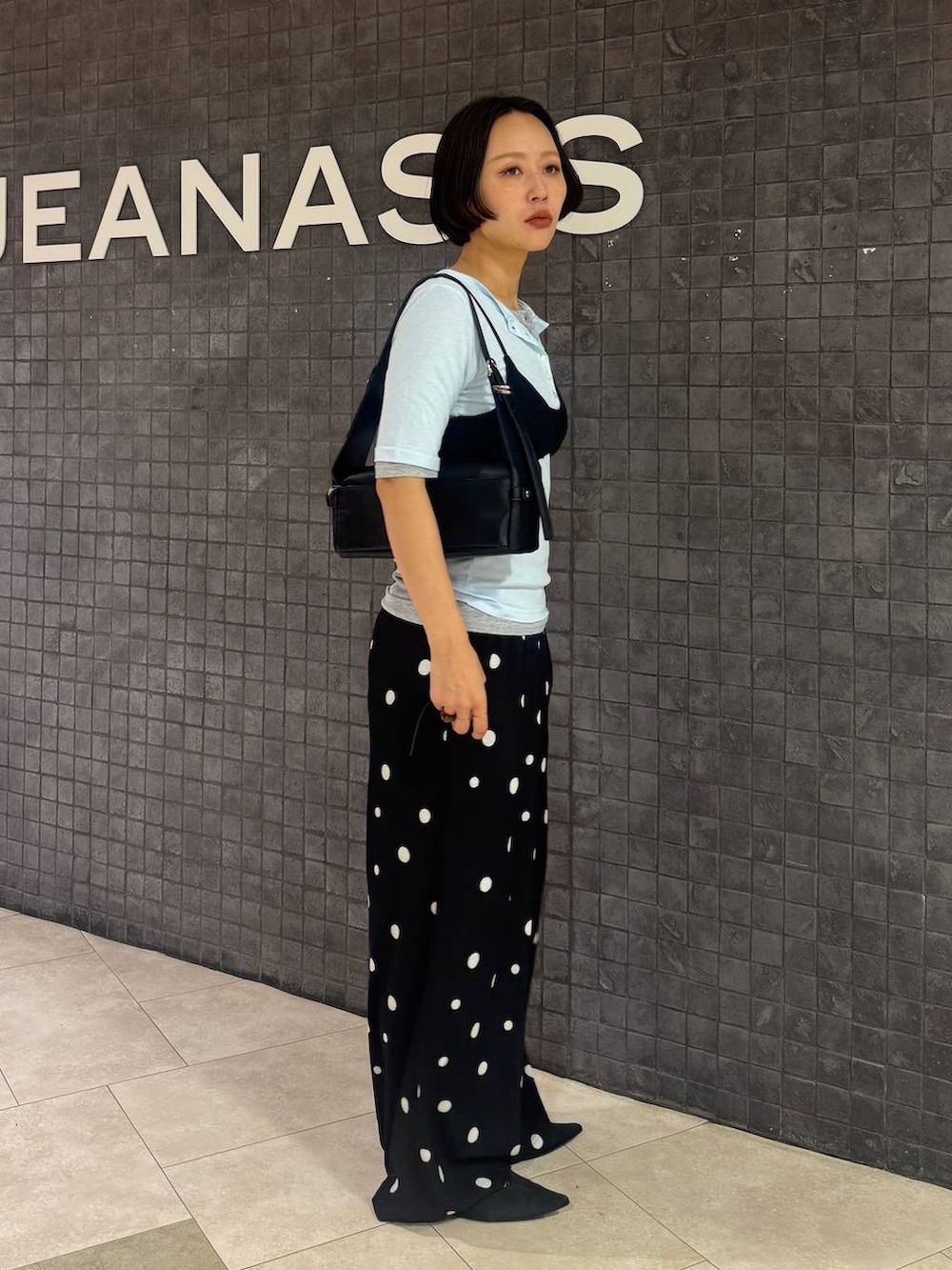 ブラック系のその他パンツ、グレー系のTシャツ/カットソー、ブラック系のショルダーバッグを着用したレディースの夏コーディネートの2枚目の写真