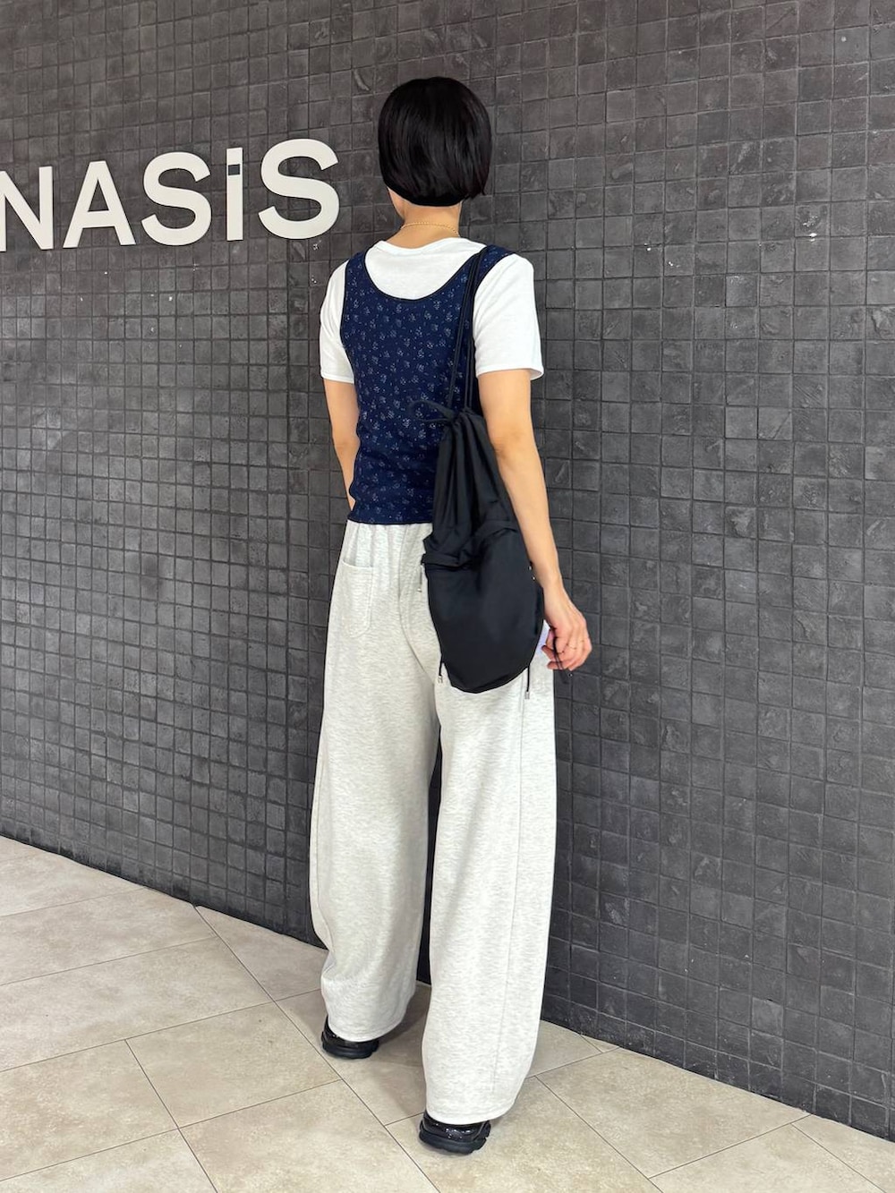 ブラック系のサンダル、ブルー系のタンクトップ、ホワイト系のTシャツ/カットソーを着用したレディースの夏コーディネートの2枚目の写真