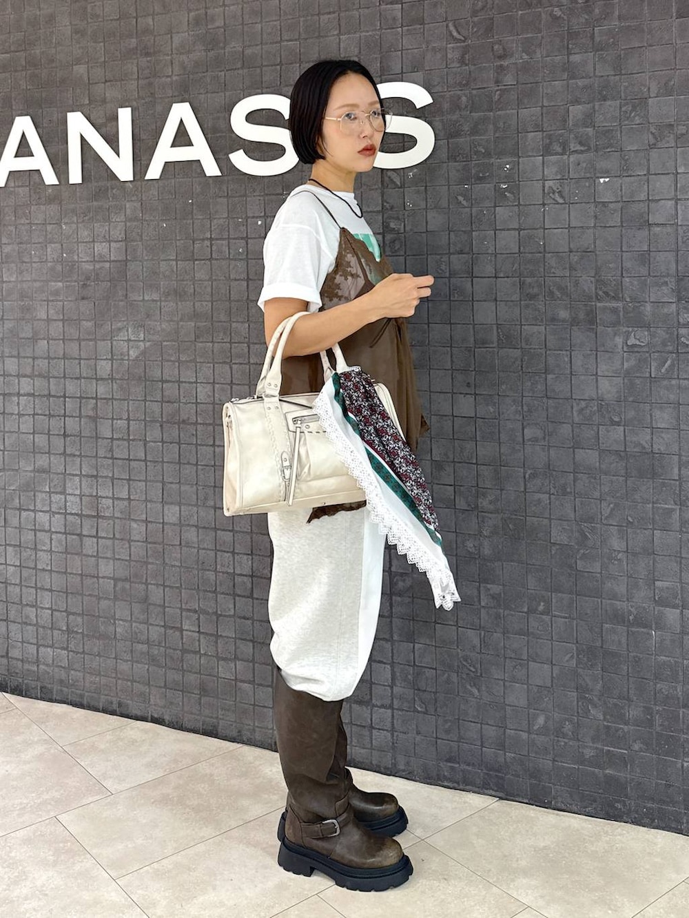 ホワイト系のTシャツ/カットソー、ホワイト系のデニムパンツ、ホワイト系のボストンバッグを着用したレディースの夏コーディネートの3枚目の写真
