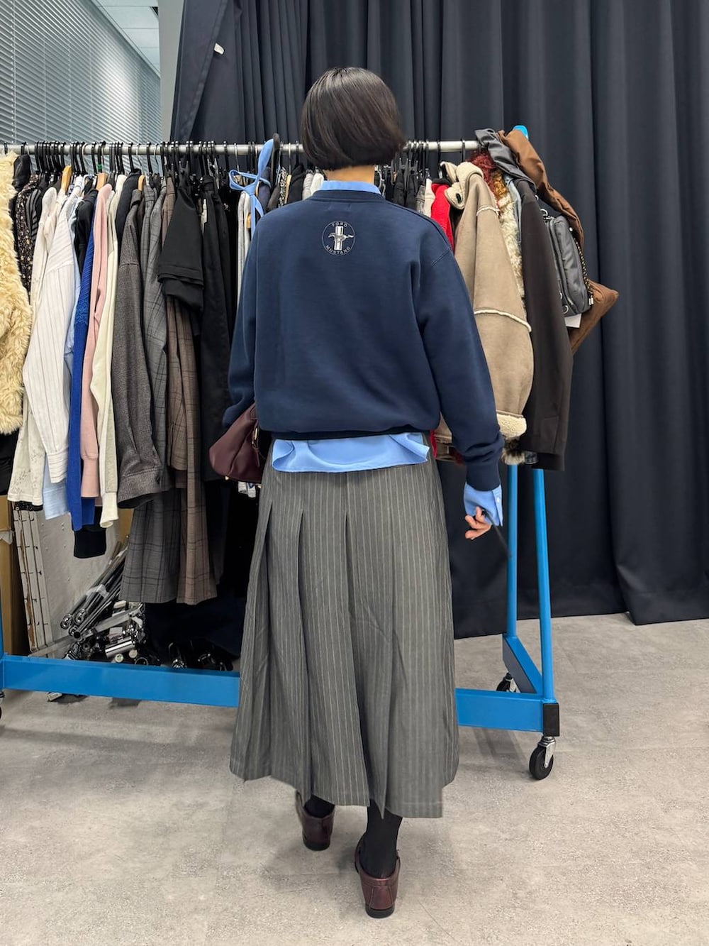 レッド系のショルダーバッグ、ブルー系のシャツ/ブラウスを着用したレディースの夏コーディネートの4枚目の写真