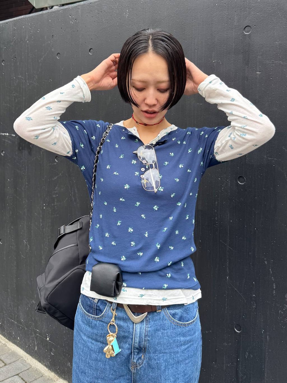 ブラック系のバックパック/リュック、ブルー系のTシャツ/カットソー、ブラウン系のベルトを着用したレディースの春コーディネートの9枚目の写真