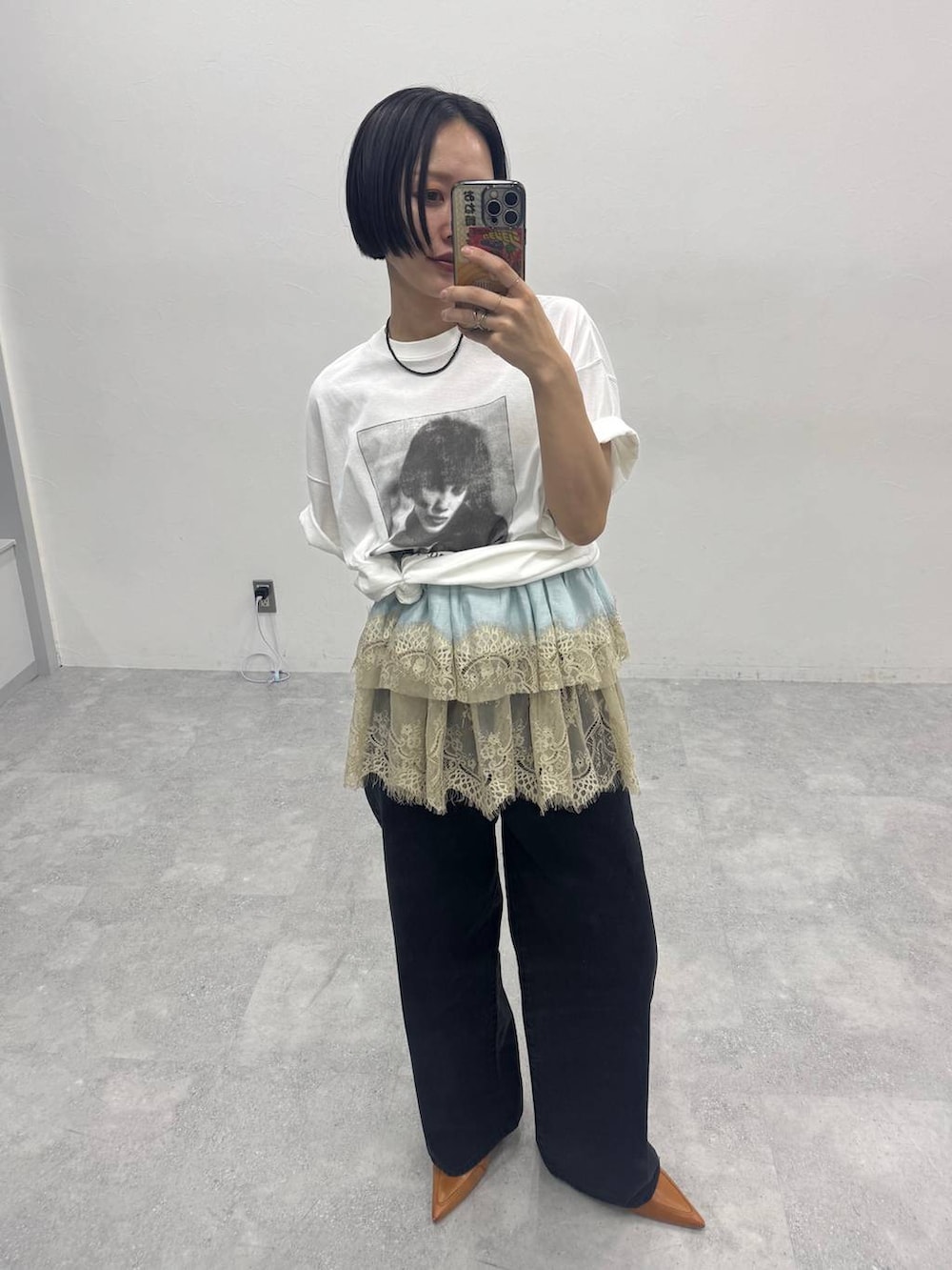 ブラウン系のパンプス、ブラック系のデニムパンツ、ホワイト系のTシャツ/カットソーを着用したレディースの春コーディネートの2枚目の写真