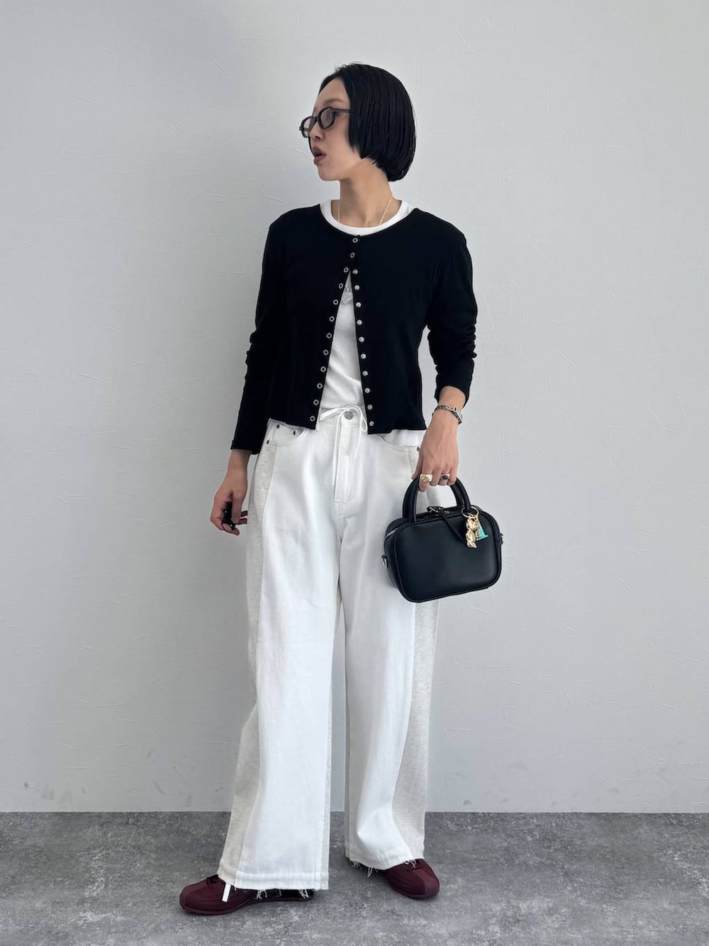 ブラック系のショルダーバッグを着用したレディースの冬コーディネートの2枚目の写真