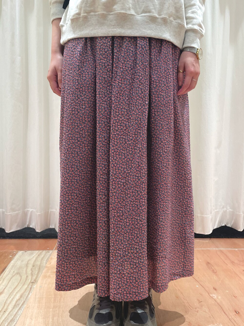 レッド系のスカート、ホワイト系のスウェットを着用したレディースの冬コーディネートの4枚目の写真