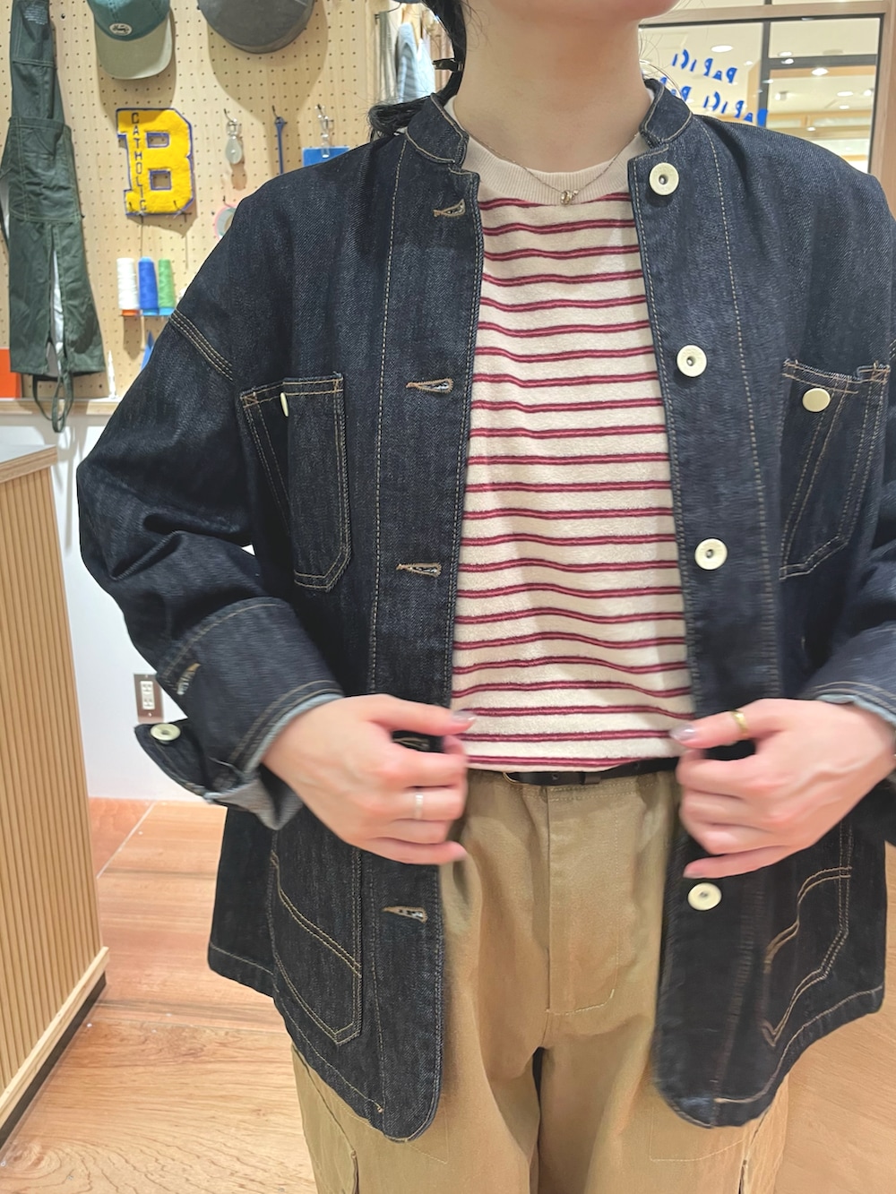 ベージュ系のカーゴパンツ、ベージュ系のTシャツ/カットソー、ブルー系のカバーオールを着用したレディースの秋コーディネートの5枚目の写真