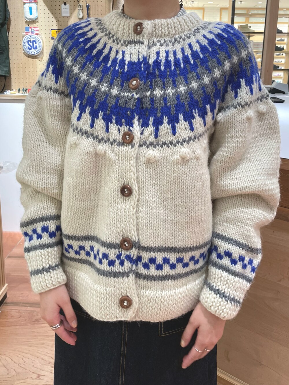 ホワイト系のカーディガン/ボレロ、グレー系のシャツ/ブラウス、ブルー系のデニムスカートを着用したレディースの秋コーディネートの5枚目の写真