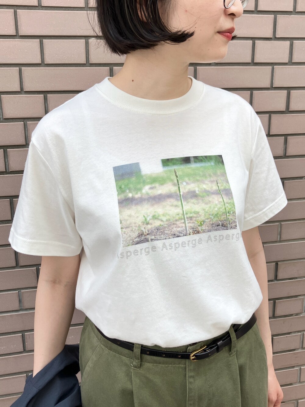 ホワイト系のTシャツ/カットソー、グリーン系のチノパンツ、ブラック系のベルトを着用したレディースの夏コーディネートの4枚目の写真