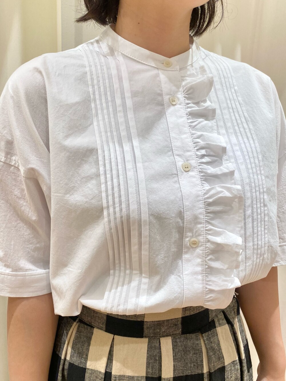 ホワイト系のシャツ/ブラウス、ベージュ系のベスト、ブラック系のスカートを着用したレディースの夏コーディネートの9枚目の写真