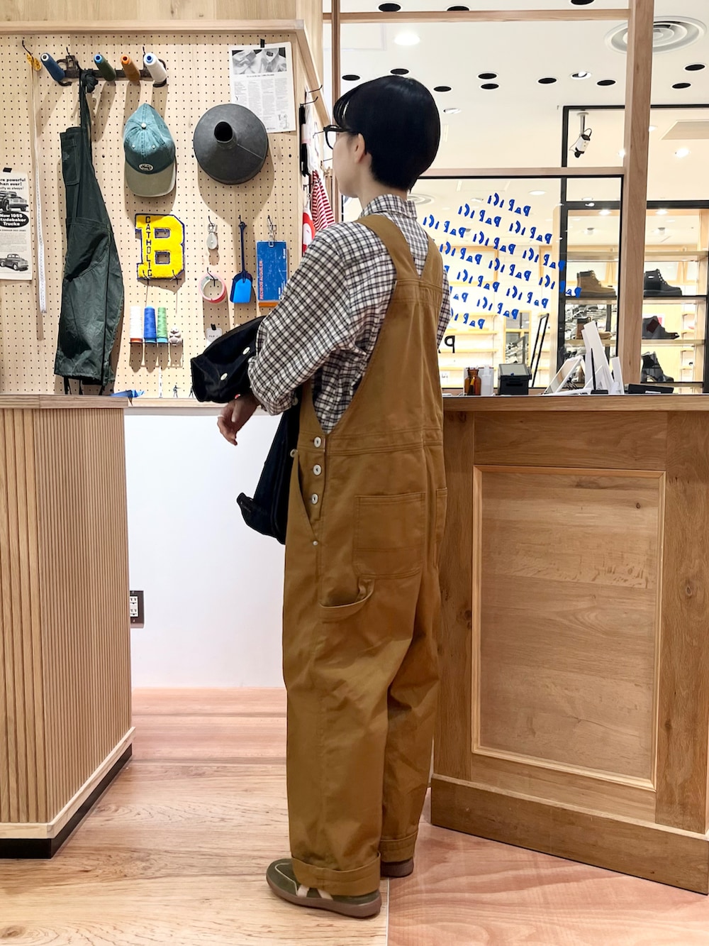 ブルー系のシャツ/ブラウス、ブルー系のカバーオール、ブラウン系のサロペット/オーバーオールを着用したレディースの秋コーディネートの4枚目の写真