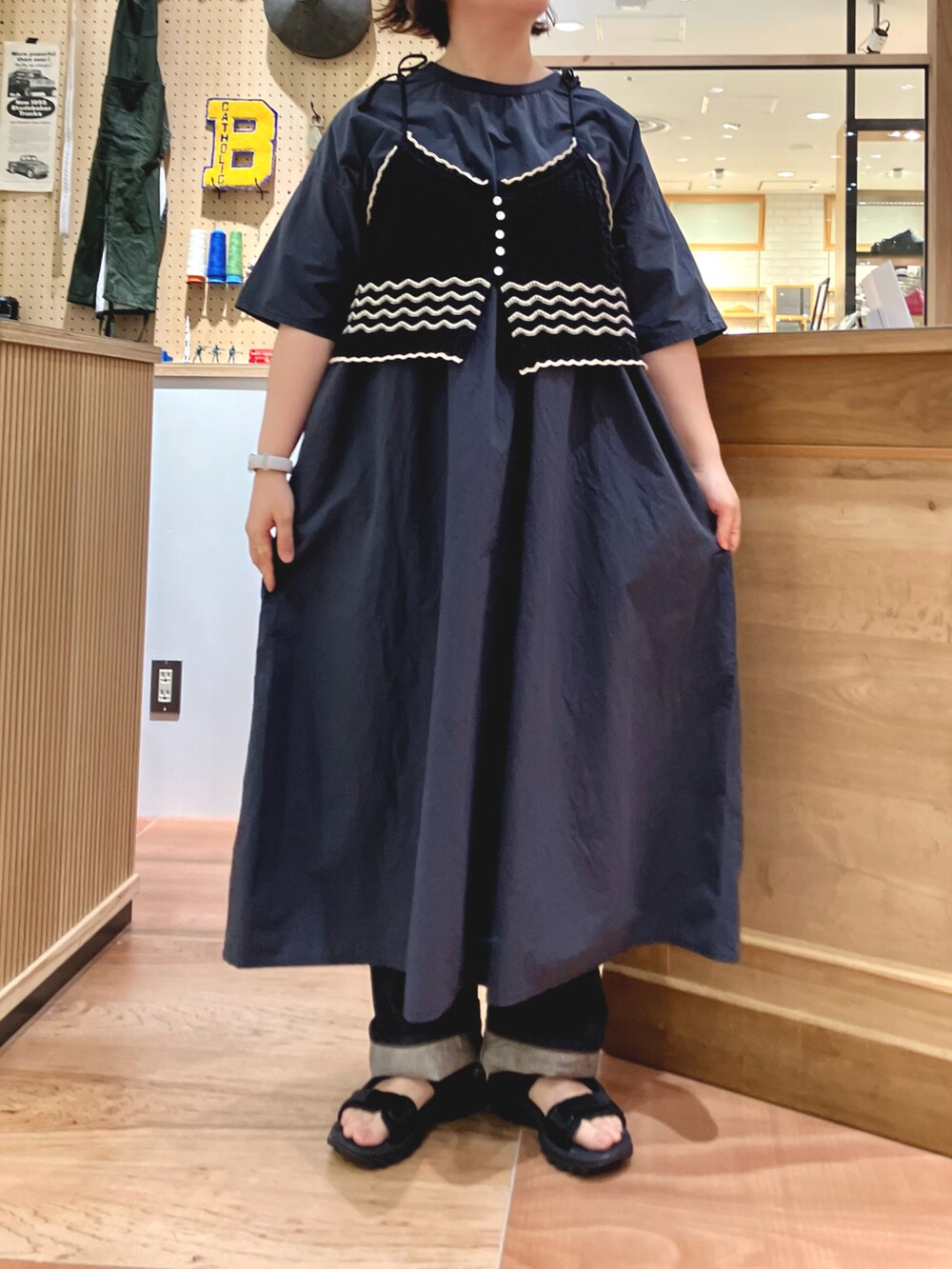 その他のワンピース、ブラック系のベスト、ブルー系のデニムパンツを着用したレディースの春コーディネートの2枚目の写真
