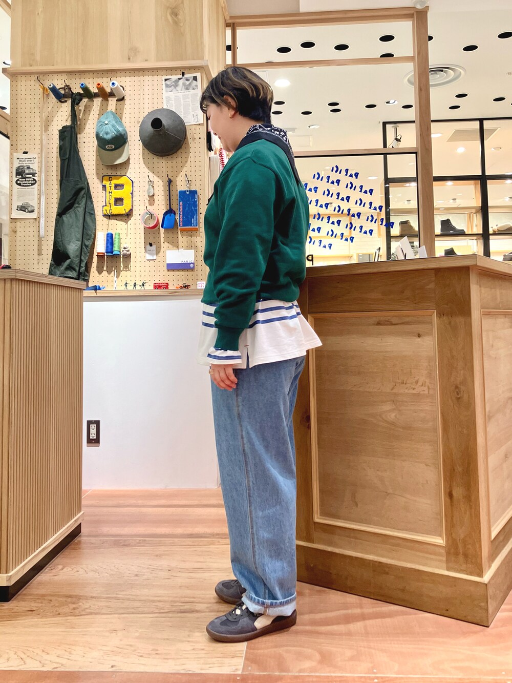 グリーン系のスウェット、ブルー系のTシャツ/カットソー、ブラック系のバンダナ/スカーフを着用したレディースの秋コーディネートの2枚目の写真