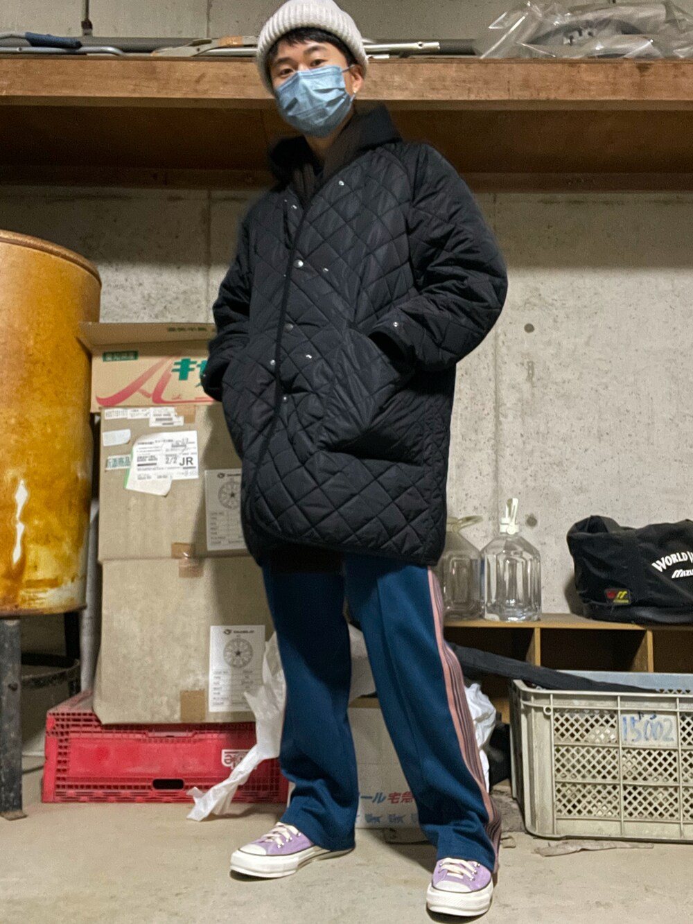 ブラック系のパーカー、グリーン系のその他パンツ、パープル系のスニーカーを着用したメンズの冬コーディネートの2枚目の写真