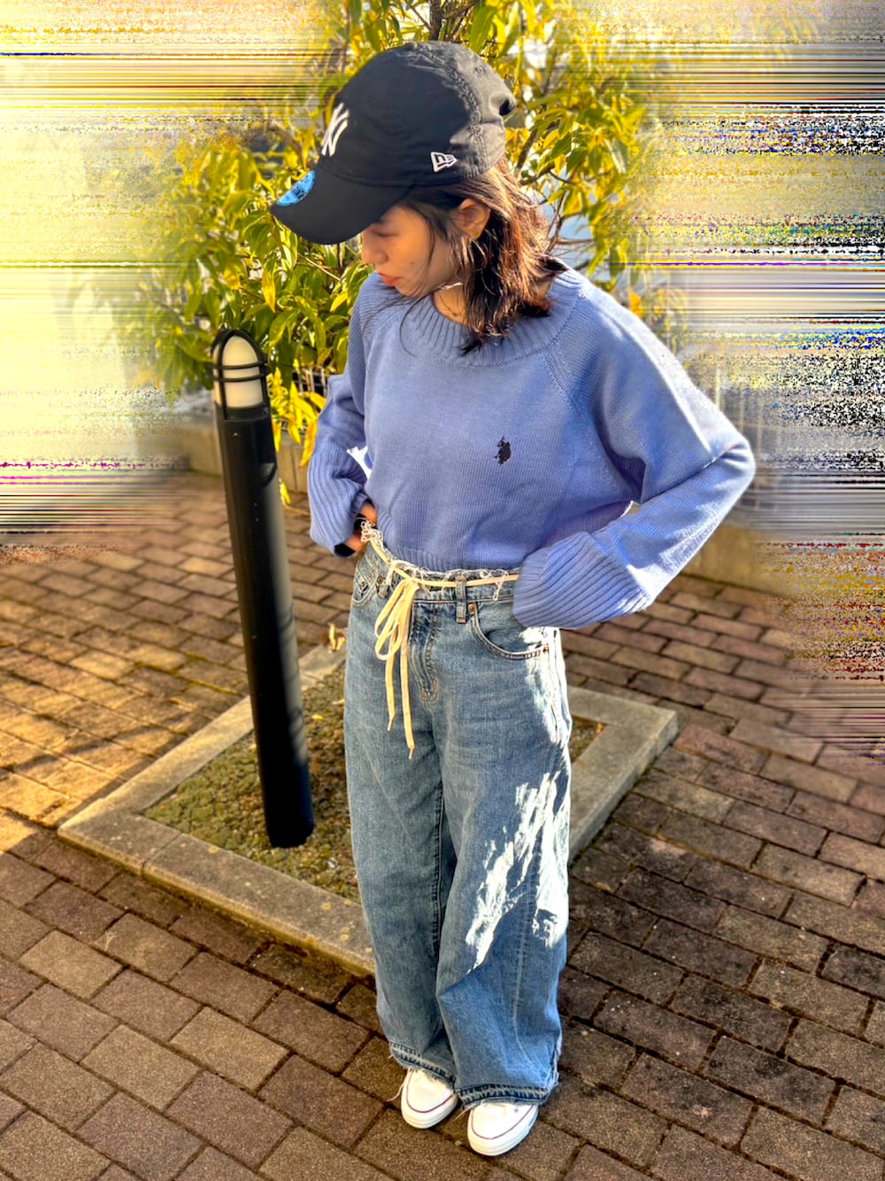 ブルー系のニット/セーター、ブルー系のデニムパンツ、ホワイト系のスニーカーを着用したレディースの冬コーディネートの2枚目の写真