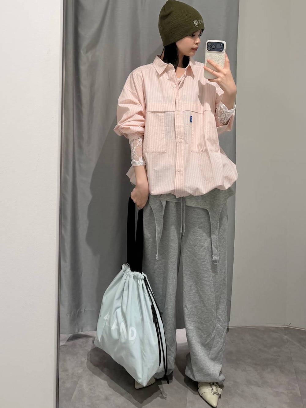 ブルー系のトートバッグ、ホワイト系のTシャツ/カットソー、ホワイト系のパンプスを着用したレディースの冬コーディネートの6枚目の写真