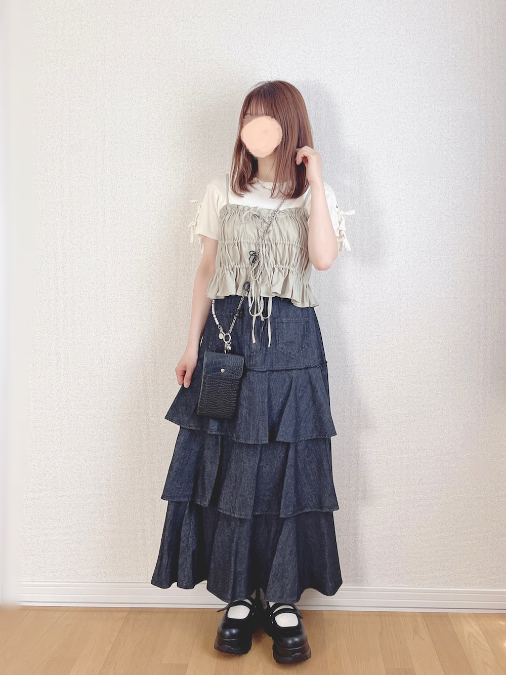 グリーン系のキャミソール、ホワイト系のTシャツ/カットソー、ブラック系のスニーカーを着用したレディースの秋コーディネートの3枚目の写真