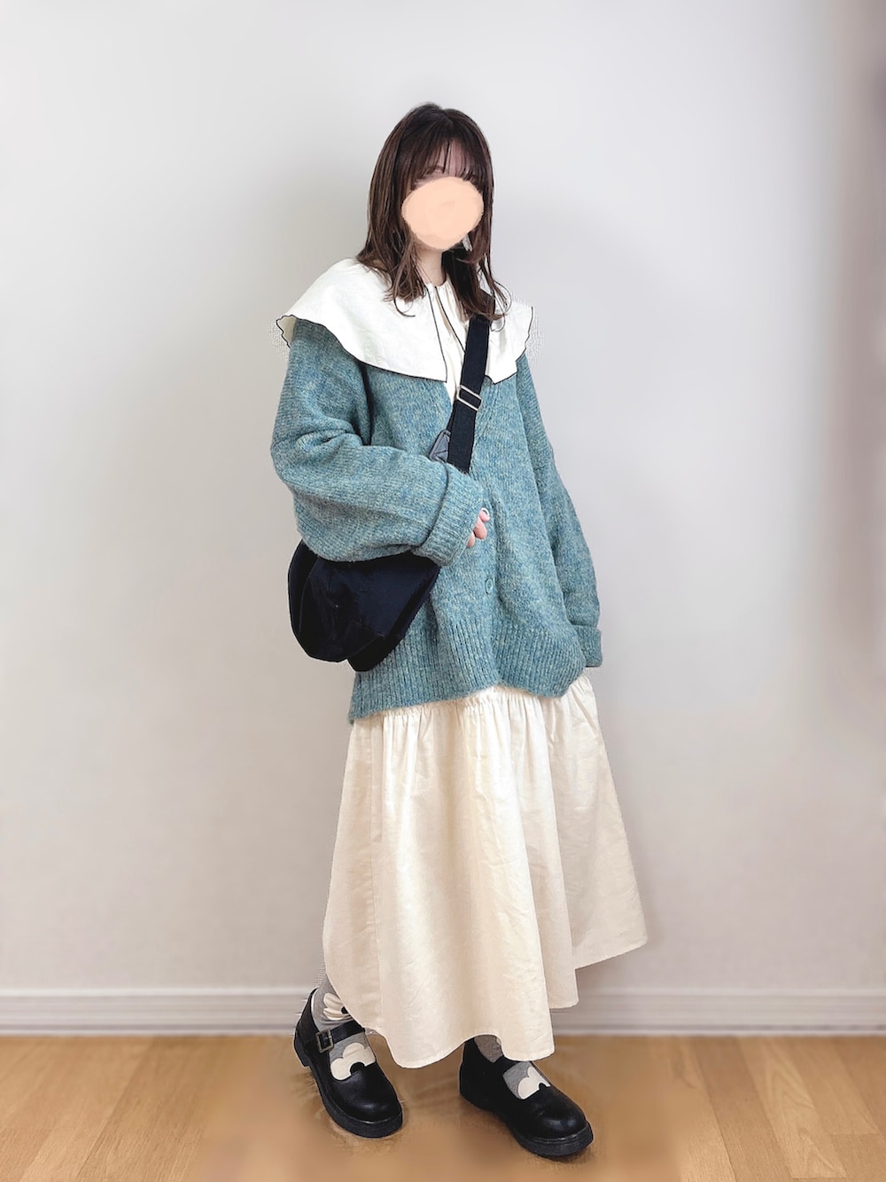 ホワイト系のワンピース、グリーン系のカーディガン/ボレロ、ブラック系のショルダーバッグを着用したレディースの秋コーディネートの2枚目の写真