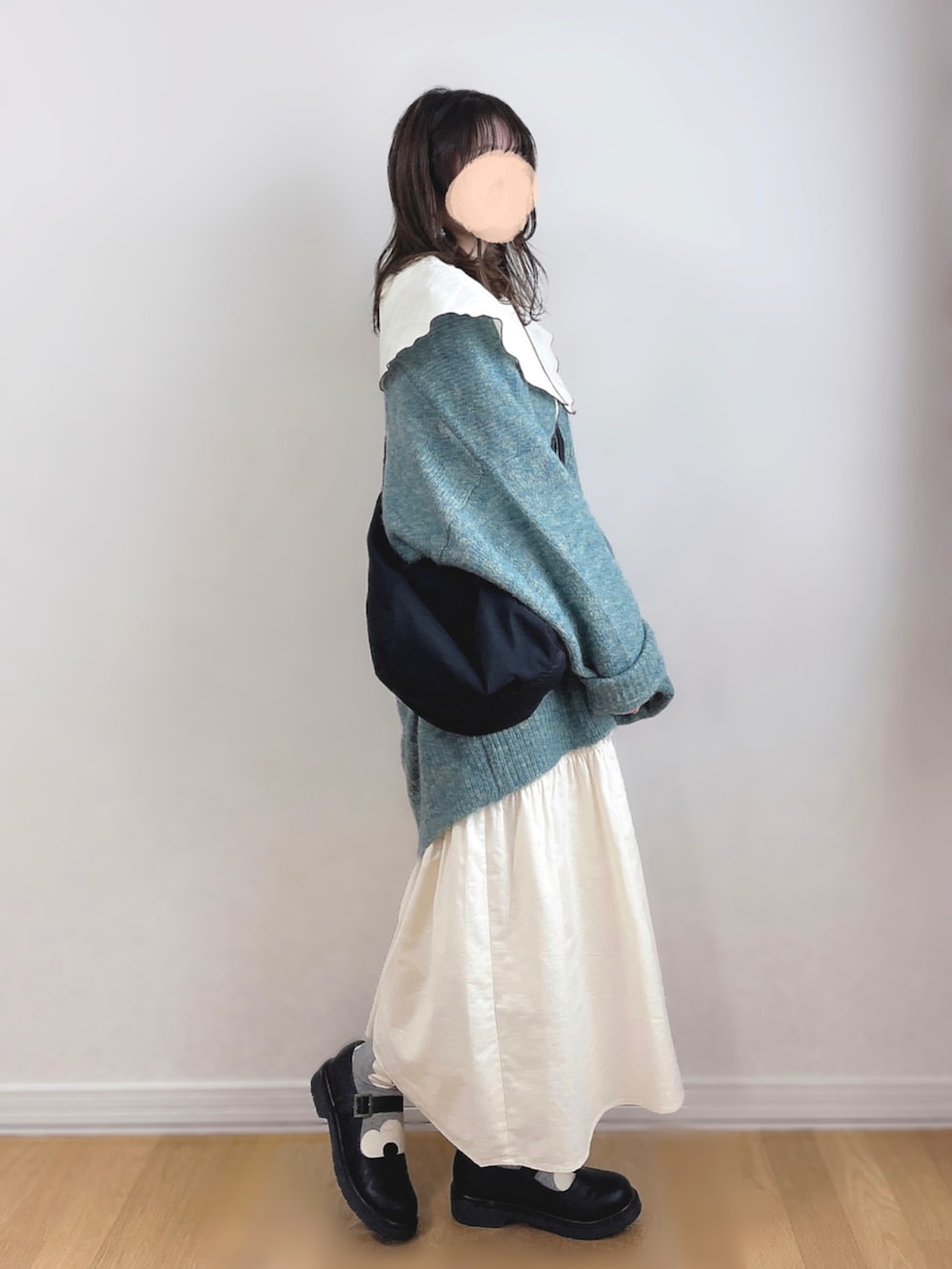 ホワイト系のワンピース、グリーン系のカーディガン/ボレロ、ブラック系のショルダーバッグを着用したレディースの秋コーディネートの3枚目の写真