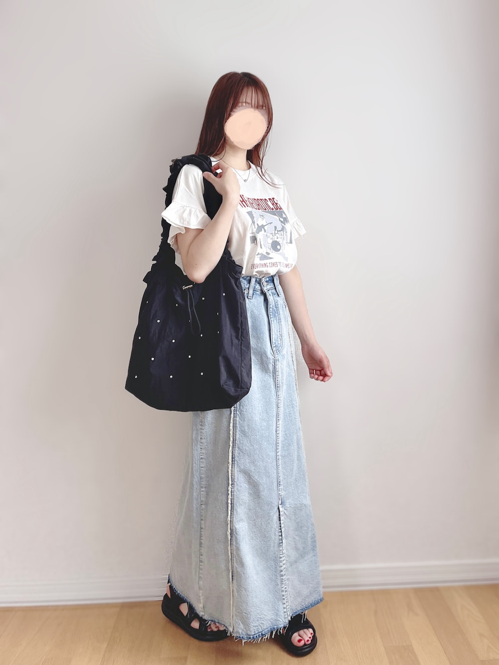 ホワイト系のTシャツ/カットソー、ブルー系のスカート、ブラック系のサンダルを着用したレディースの秋コーディネートの3枚目の写真