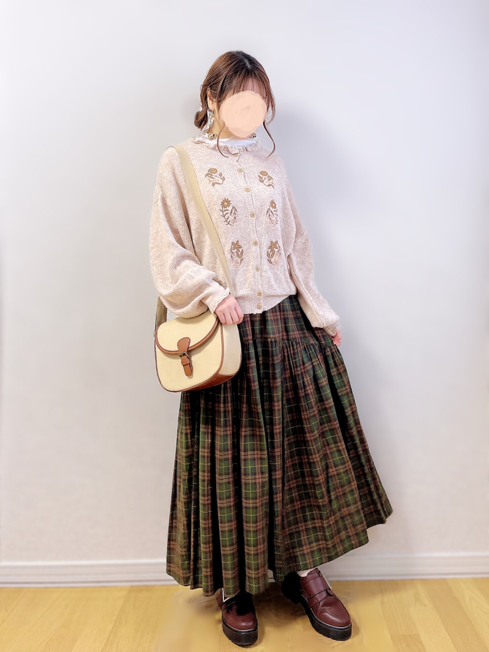 ホワイト系のTシャツ/カットソー、ブラウン系のスカート、ベージュ系のショルダーバッグを着用したレディースの冬コーディネートの3枚目の写真