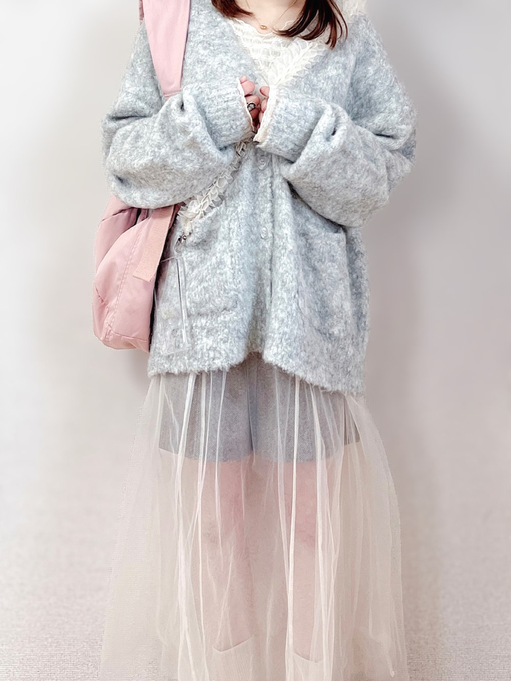 ベージュ系のカーディガン/ボレロ、グレー系のワンピース、ピンク系のショルダーバッグを着用したレディースの冬コーディネートの4枚目の写真