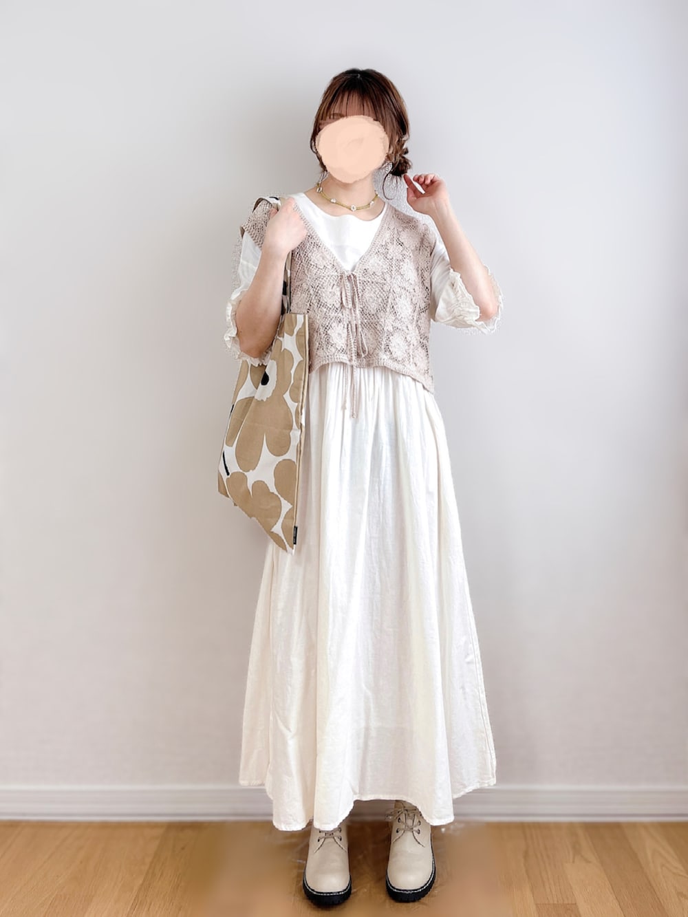 ホワイト系のワンピース、ベージュ系のトートバッグ、グリーン系のネックレスを着用したレディースの夏コーディネートの3枚目の写真