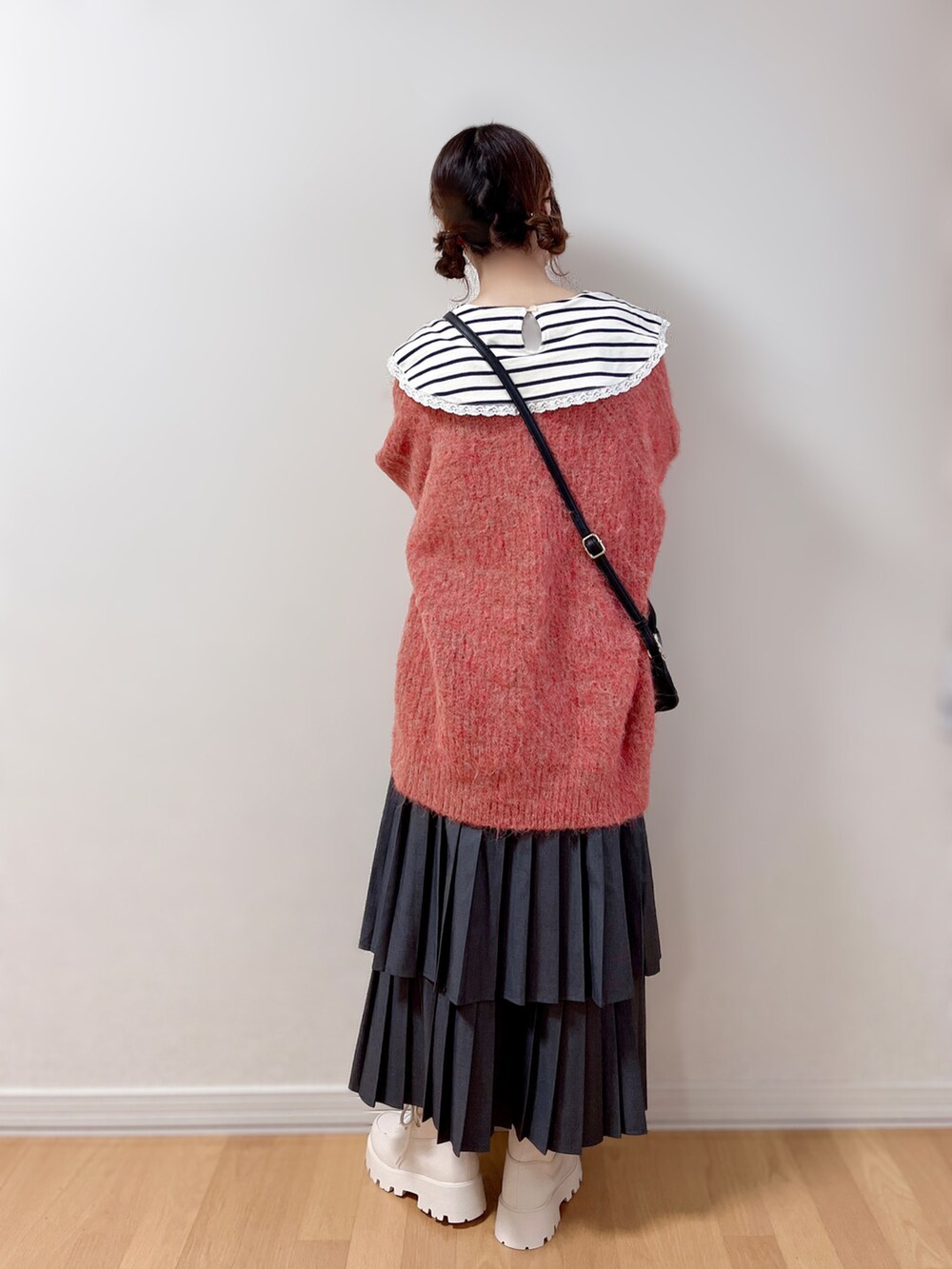 ブラック系のショルダーバッグ、ホワイト系のブローチ/コサージュを着用したレディースの冬コーディネートの5枚目の写真