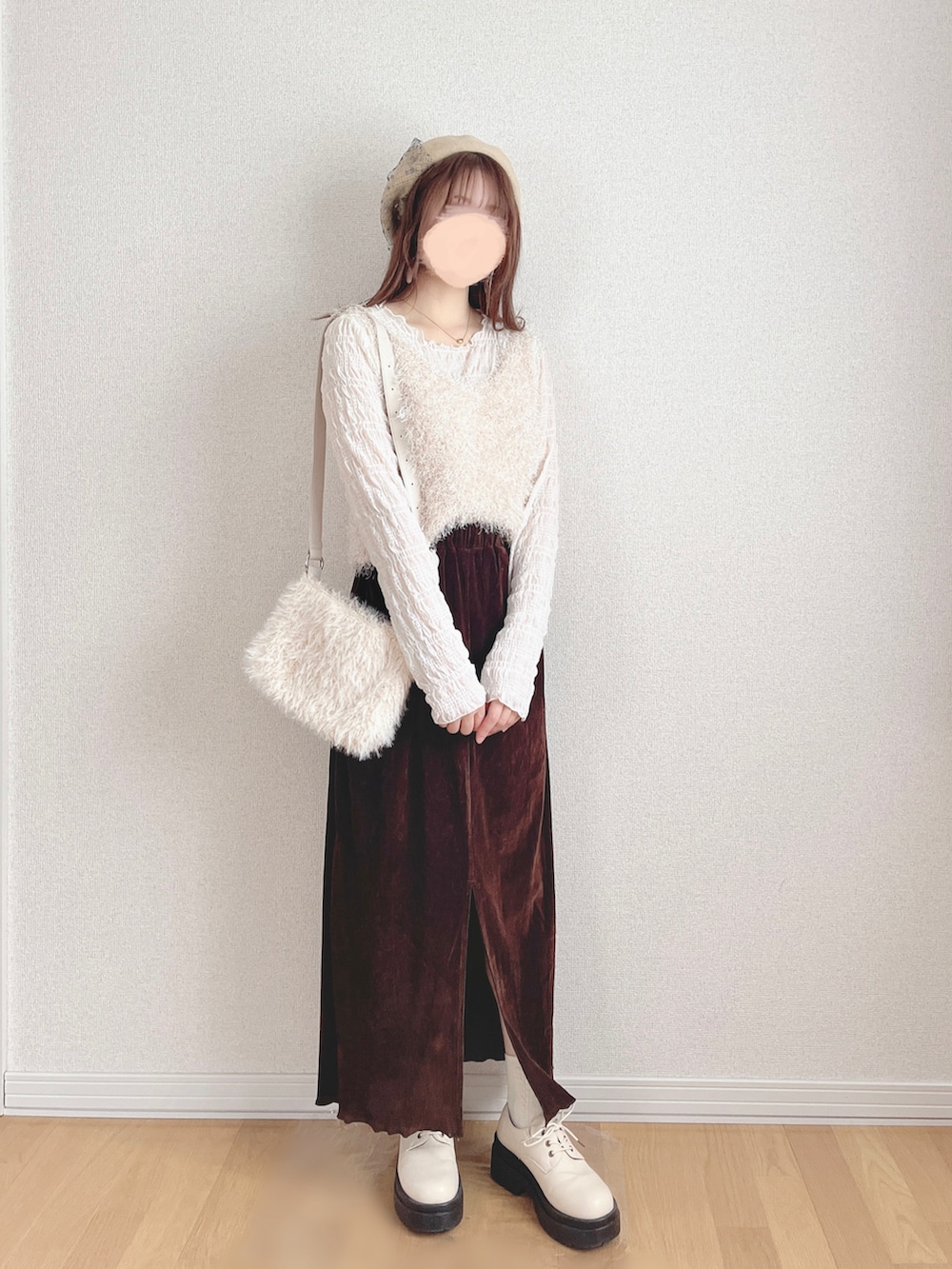 ホワイト系のカーディガン/ボレロ、ホワイト系のキャミソール、ブラウン系のスカートを着用したレディースの冬コーディネートの2枚目の写真